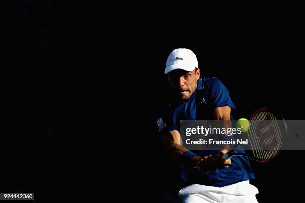 Roberto Bautista Agut of Spain plays a backhand in his match against Florian Mayer of Germany during day one of the ATP Dubai Duty Free Tennis...