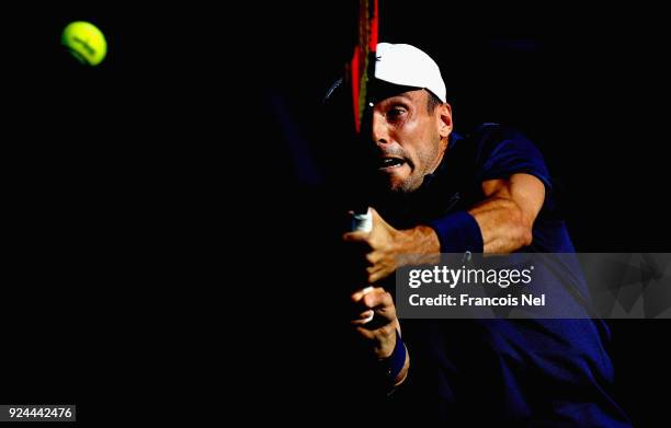 Roberto Bautista Agut of Spain plays a backhand in his match against Florian Mayer of Germany during day one of the ATP Dubai Duty Free Tennis...