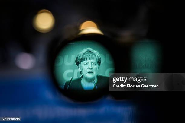 German Chancellor Angela Merkel, seen through an ocular, speaks at the 30th German Christian Democrats party congress on February 26, 2018 in Berlin,...