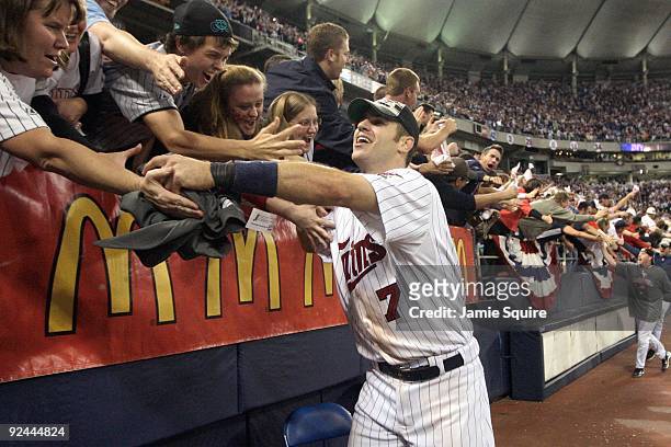 Joe Mauer of the Minnesota Twins celebrates with fans after winning the American League tiebreaker game against the Detroit Tigers on October 6, 2009...