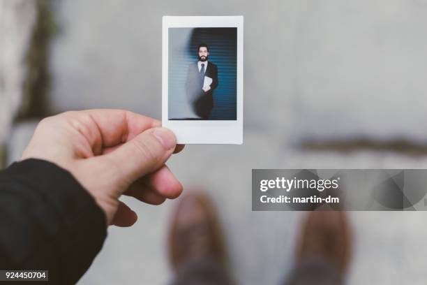 businessman showing instant portrait - human hand photos stock pictures, royalty-free photos & images