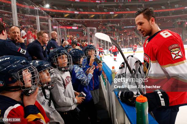 Alex Petrovic of the Florida Panthers chats with young hockey fans during warm ups prior to the start of the game against the Pittsburgh Penguins at...