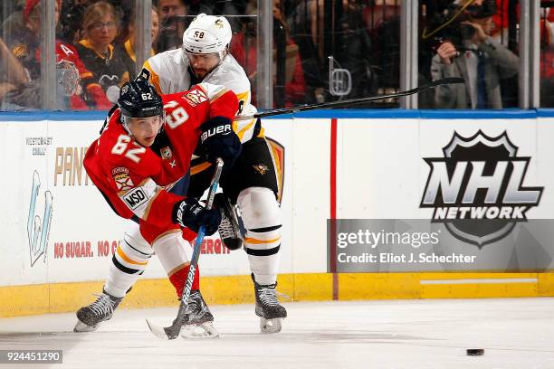 Kris Letang of the Pittsburgh Penguins tangles with Denis Malgin of the Florida Panthers at the BB&T Center on February 24, 2018 in Sunrise, Florida.