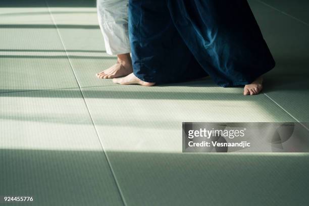 teen boy with his sansei practicing in dojo - akido stock pictures, royalty-free photos & images