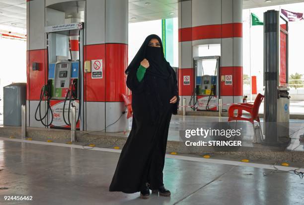 Murfa Bukhalid, a Saudi petrol station supervisor, poses for picture at the petrol station where she works in Khobar, some 400 kilometres east of...