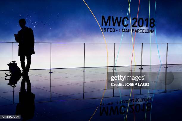 Man visits the Mobile World Congress , the world's biggest mobile fair, on February 26, 2018 in Barcelona. - the Mobile World Congress is held in...