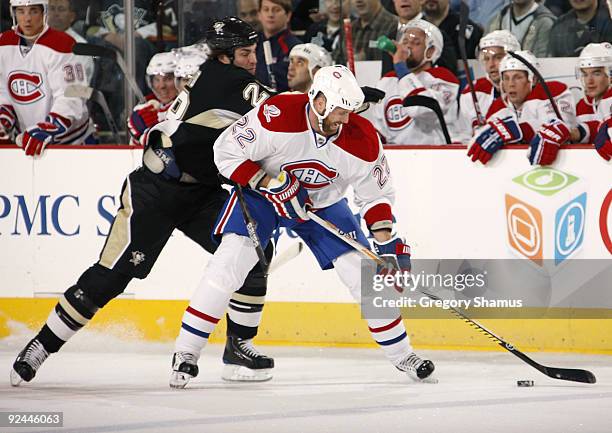 Paul Mara of the Montreal Canadiens controls the puck in front of the defense of Eric Godard of the Pittsburgh Penguins on October 28, 2009 at Mellon...