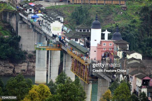 View of buildings of various styles on a 400-meter-long bridge in a tourism attraction in southwest China's Chongqing Municipality Friday Feb. 23,...