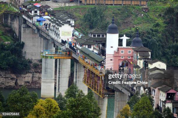 View of buildings of various styles on a 400-meter-long bridge in a tourism attraction in southwest China's Chongqing Municipality Friday Feb. 23,...