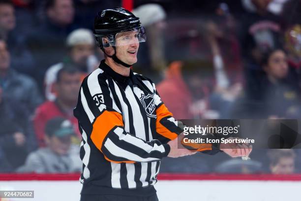 Referee Kevin Pollock adjusts his equipment as there is a stoppage in play during second period National Hockey League action between the...