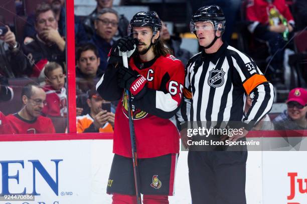 Ottawa Senators Defenceman Erik Karlsson chats with Referee Kevin Pollock as there is a stoppage in play during third period National Hockey League...