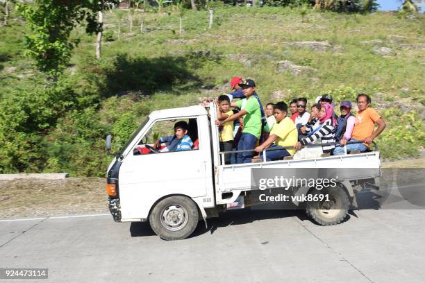 a lot of people driving on a truck - filipino tricycle stock pictures, royalty-free photos & images