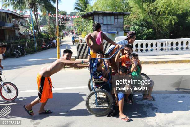 a lot of kids have fun while riding on a tricycle - tricycle philippines stock pictures, royalty-free photos & images