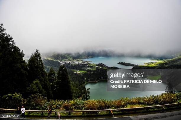 Tourists stand on top of Sete Cidades lagoon in Sao Miguel island, Azores, Portugal on February 23, 2018.