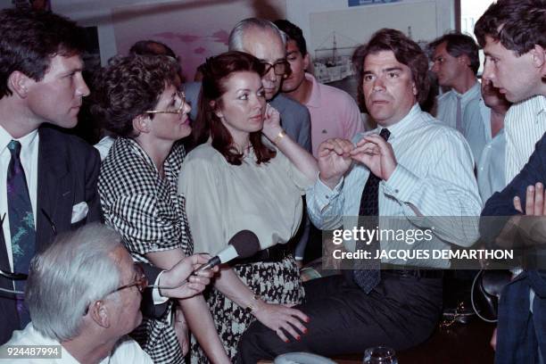 "Presidential majority" candidate Bernard Tapie passes comment on the results of the legislative election as his wife Dominique Tapie looks on , on...