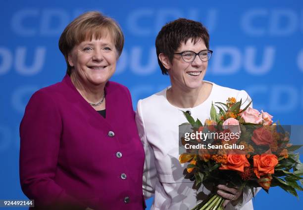 German Chancellor and Chairwoman of the German Christian Democrats Angela Merkel and Annegret Kramp-Karrenbauer smile to delegates moments after...