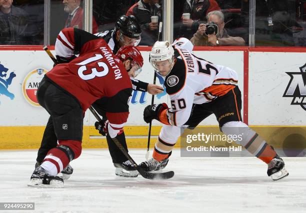 Freddie Hamilton of the Arizona Coyotes takes a faceoff against Antoine Vermette of the Anaheim Ducks at Gila River Arena on February 24, 2018 in...