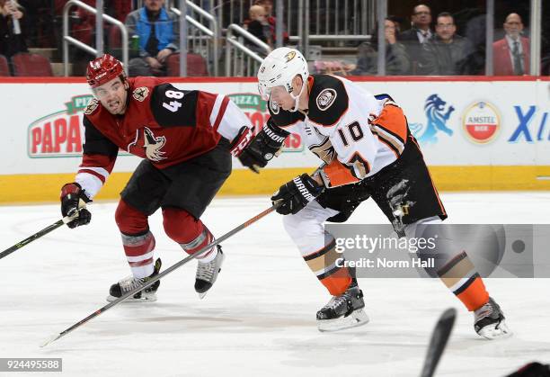 Corey Perry of the Anaheim Ducks races up ice against Jordan Martinook of the Arizona Coyotes at Gila River Arena on February 24, 2018 in Glendale,...