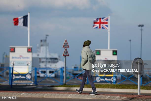 Man walks on February 26 in front of France and United Kingdom's flags outside the port of Ouistreham, near Caen, Northwestern France. - More than a...