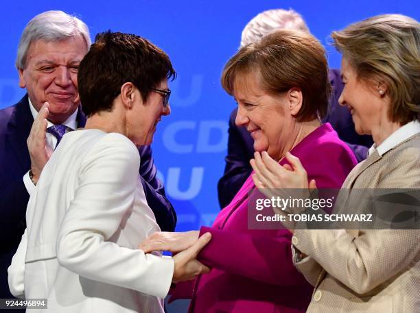 German Chancellor Angela Merkel congratulates Saarland's State Premier Annegret Kramp-Karrenbauer after she was elected secretary general of the...