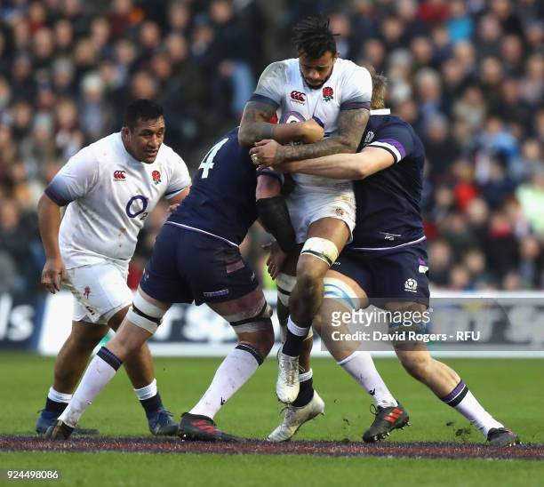 Courtney Lawes of England is tackled by Grant Gilchrist and John Barclay during the NatWest Six Nations match between Scotland and England at...