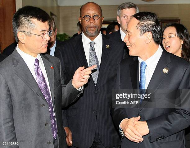 Commerce Secretary Gary Locke and China's Vice Premier Wang Qishan talk while walking to a meeting room in Hangzhou on October 28, 2009 as US Trade...