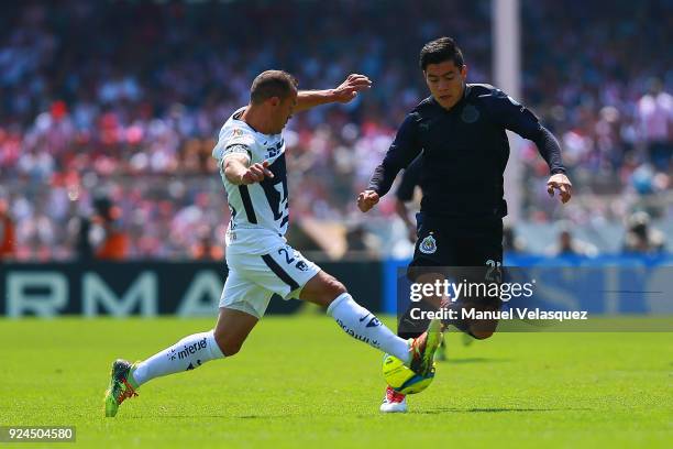 Marcelo Diaz of Pumas struggles for the ball with Michael Perez of Chivas during the 9th round match between Pumas UNAM and Chivas as part of the...