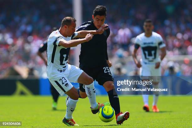 Marcelo Diaz of Pumas struggles for the ball with Michael Perez of Chivas during the 9th round match between Pumas UNAM and Chivas as part of the...