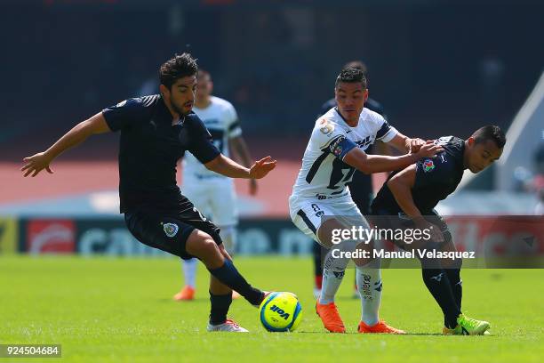 Pablo Barrera of Pumas struggles for the ball with Rodolfo Pizarro and Edwin Hernandez of Chivas during the 9th round match between Pumas UNAM and...