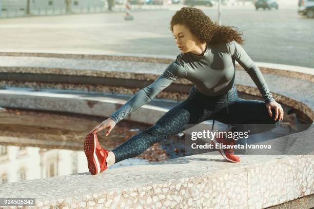 sportswoman doing side lunges - form fitted stock pictures, royalty-free photos & images