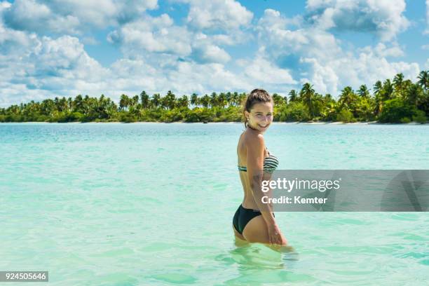 happy teenage girl standing in front of an caribbean island - puerto plata imagens e fotografias de stock