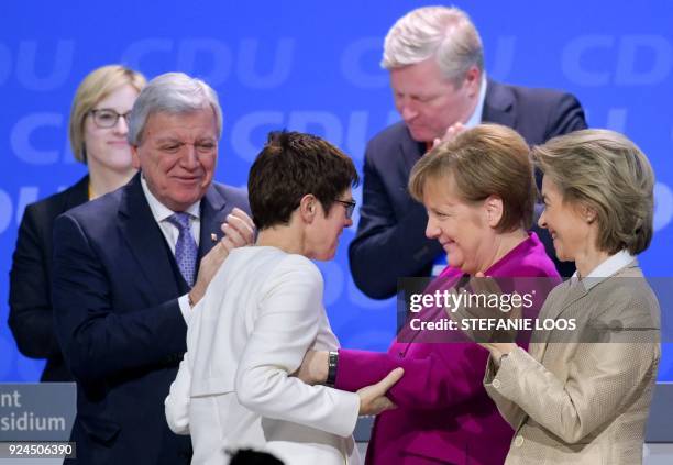 German Chancellor Angela Merkel congratulates Saarland's State Premier Annegret Kramp-Karrenbauer who was elected secretary general of the Christian...