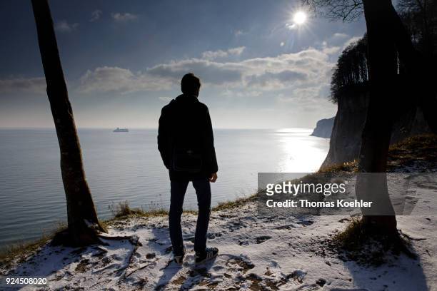Glowe, Germany A man looks at the Baltic Sea. Kieler Ufer in winter in the Jasmund National Park on the island of Ruegen on February 07, 2018 in...