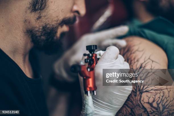 tattoo artist working - tattoo spectacular stock pictures, royalty-free photos & images