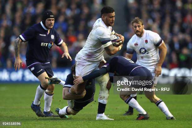 Nathan Hughes of England is tackled by Hamish Watson and Greig Laidlaw during the NatWest Six Nations match between Scotland and England at...