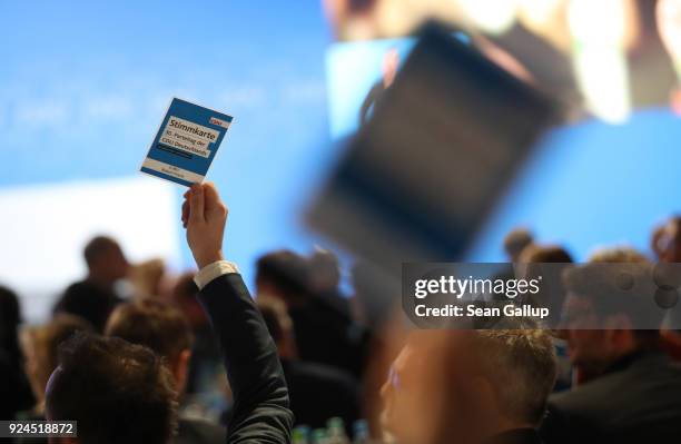 Delegates holds up cards to vote against the coalition contract with the German Social Democrats during the 30th German Christian Democrats party...