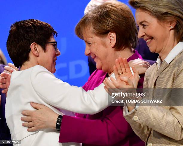 German Chancellor Angela Merkel hugs Saarland's State Premier Annegret Kramp-Karrenbauer who was elected secretary general of the Christian...