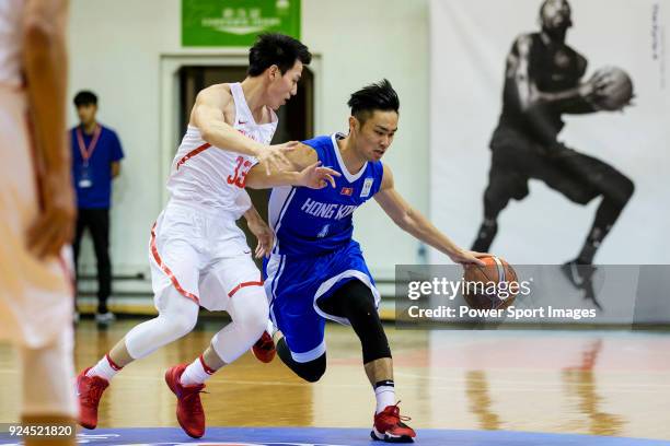 Choi Kwan Tsai of Hong Kong in action against Qian Wu of China during the FIBA Basketball World Cup 2019 Asian Qualifier Group A match between Hong...