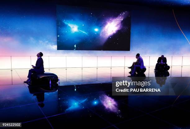 Some people sit at the Huawei stand at the Mobile World Congress , the world's biggest mobile fair, on February 26, 2018 in Barcelona. - The Mobile...