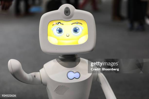 Robelf, a multi-camera home security robot, waves as it travels along the hall floor during the opening day of the Mobile World Congress in...