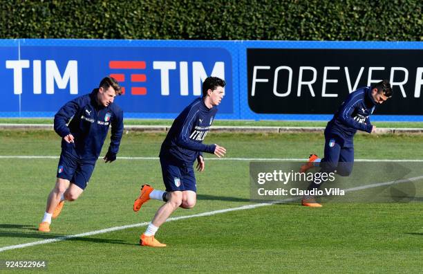 Andrea Pinamonti; Alessandro Bastoni and Federico Di Francesco of Italy in action during a training session at Italy club's training ground at...