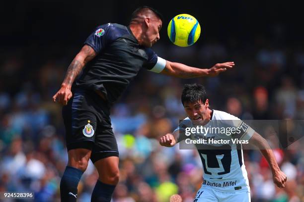 Carlos Salcido of Chivas struggles for the ball with Matias Alustiza of Pumas during the 9th round match between Pumas UNAM and Chivas as part of the...