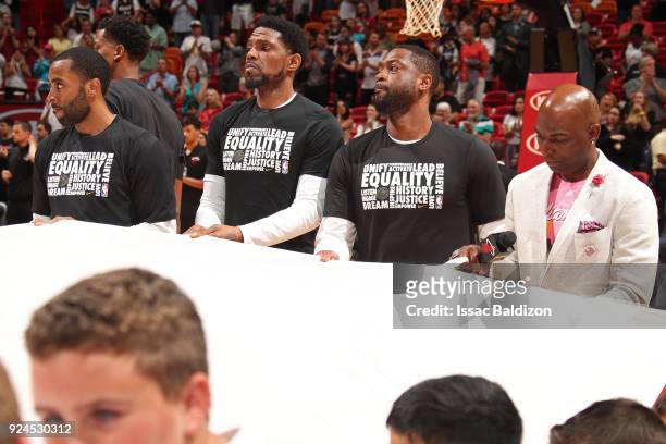 Udonis Haslem and Dwyane Wade of the Miami Heat hold the Marjory Stoneman Douglas HS flag prior to the game against the Memphis Grizzlies on February...