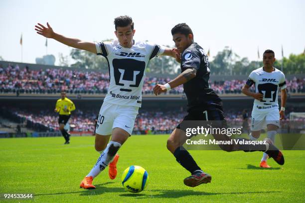 Alan Mozo of Pumas struggles for the ball with Orbelin Pineda of Chivas during the 9th round match between Pumas UNAM and Chivas as part of the...