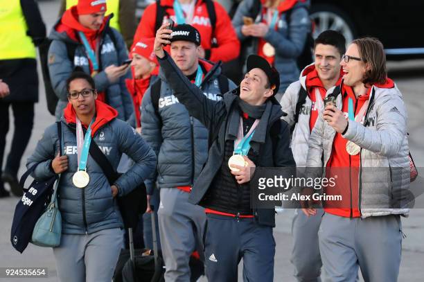 Mariama Jamanka, Eric Frenzel and Christian Ehrhoff walk off the Lufthansa plane during the welcome ceremony for the members of Team Germany after...