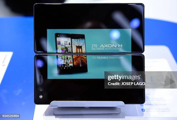 Picture shows the new ZTE's dual screens foldable smartphone AXON M on the first day of the Mobile World Congress on February 26, 2018 in Barcelona....