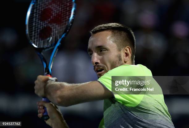 Viktor Troicki of Serbia plays a backhand in his match against Marcos Bagdatis of Cyprus during day one of the ATP Dubai Duty Free Tennis...