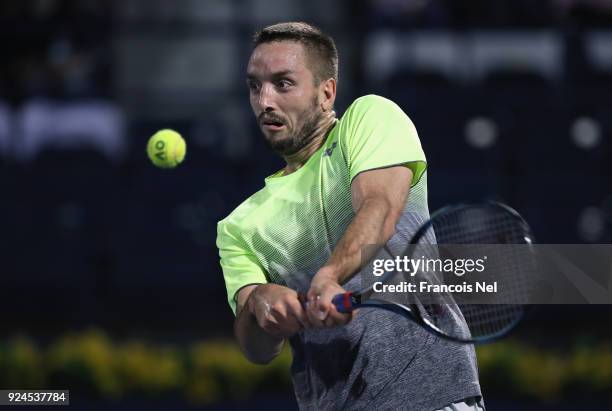 Viktor Troicki of Serbia plays a backhand in his match against Marcos Bagdatis of Cyprus during day one of the ATP Dubai Duty Free Tennis...