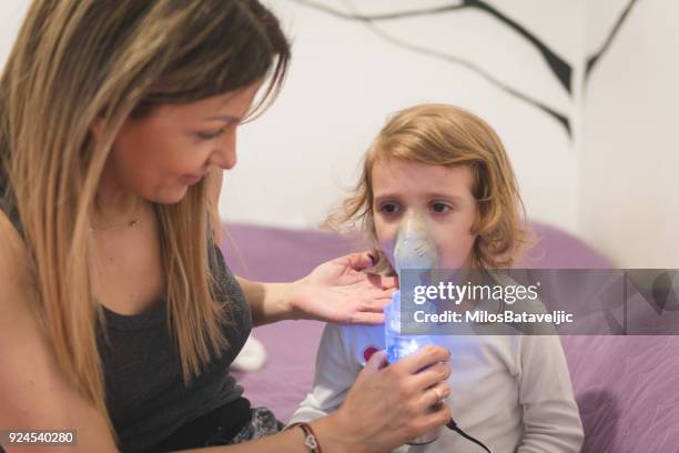 little girl wearing inhaling mask - inhalation stock pictures, royalty-free photos & images
