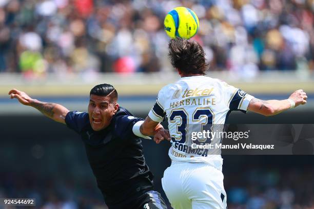Mauro Formica of Pumas heads for the ball with Carlos Salcido of Chivas during the 9th round match between Pumas UNAM and Chivas as part of the...
